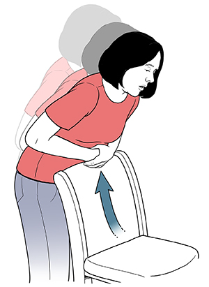 Mujer inclinada sobre el respaldo de una silla para realizar la maniobra de autosalvamento para casos de atragantamiento.